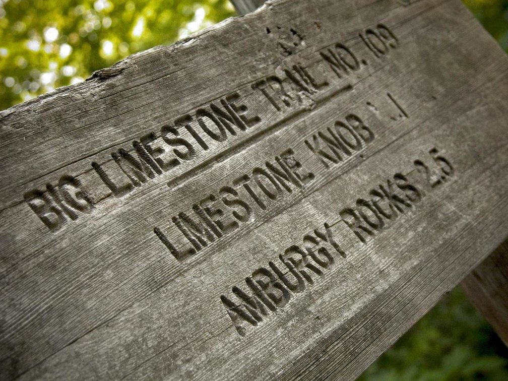 Carved wood trail mileage sign
